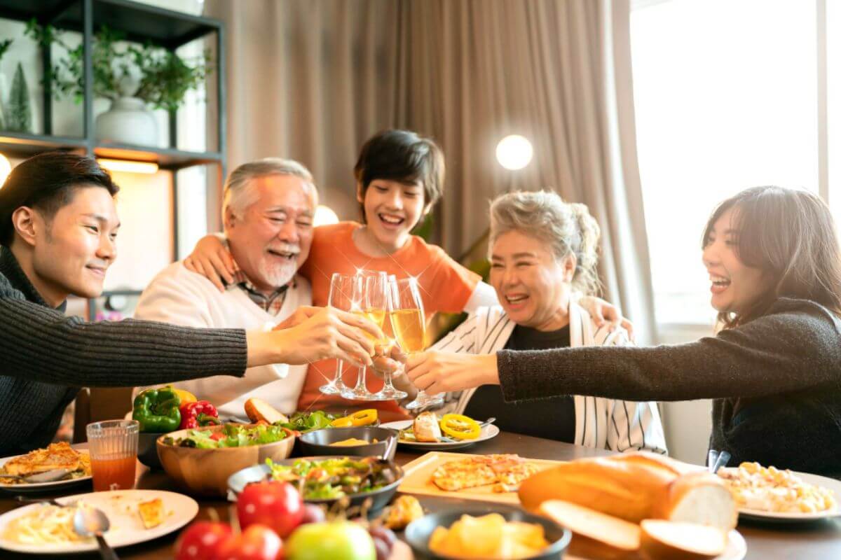 Family enjoying a festive meal together with catered food and drinks during a special gathering.