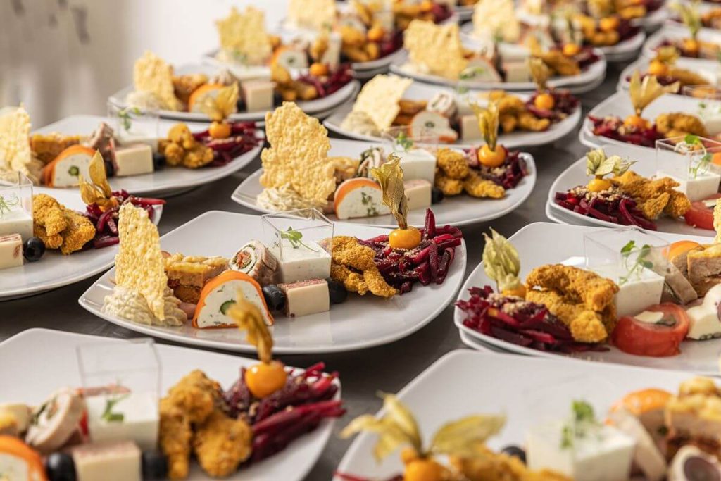 Rows of customized plated wedding dishes prepared for a refined reception menu