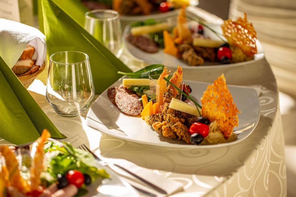 Plated event dishes with colorful ingredients and refined presentation for a quality catering menu